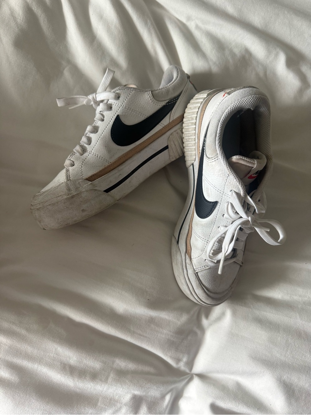 Nike White Sneakers with Black Swoosh and Beige Accent